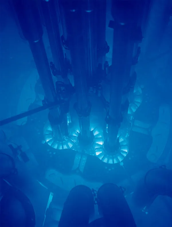 Picture is a photograph of the blue glow in a reactor pool.