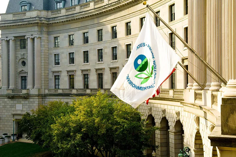 The flag of the United States Environmental Protection Agency - USEPA flies from a building.