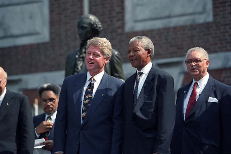 A photograph of South African President Nelson Mandela standing with U.S. President Bill Clinton.