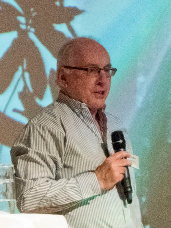 Paul D. N. Herbert, a Canadian biologist,  speaks into a microphone.