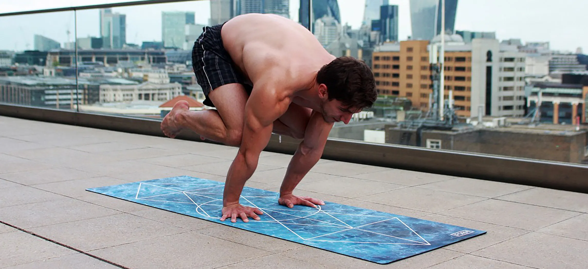 This photo shows a man executing a yoga pose.