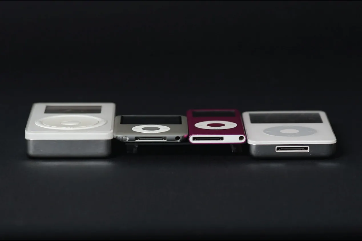 Four ipods of different sizes lay next to each other. 