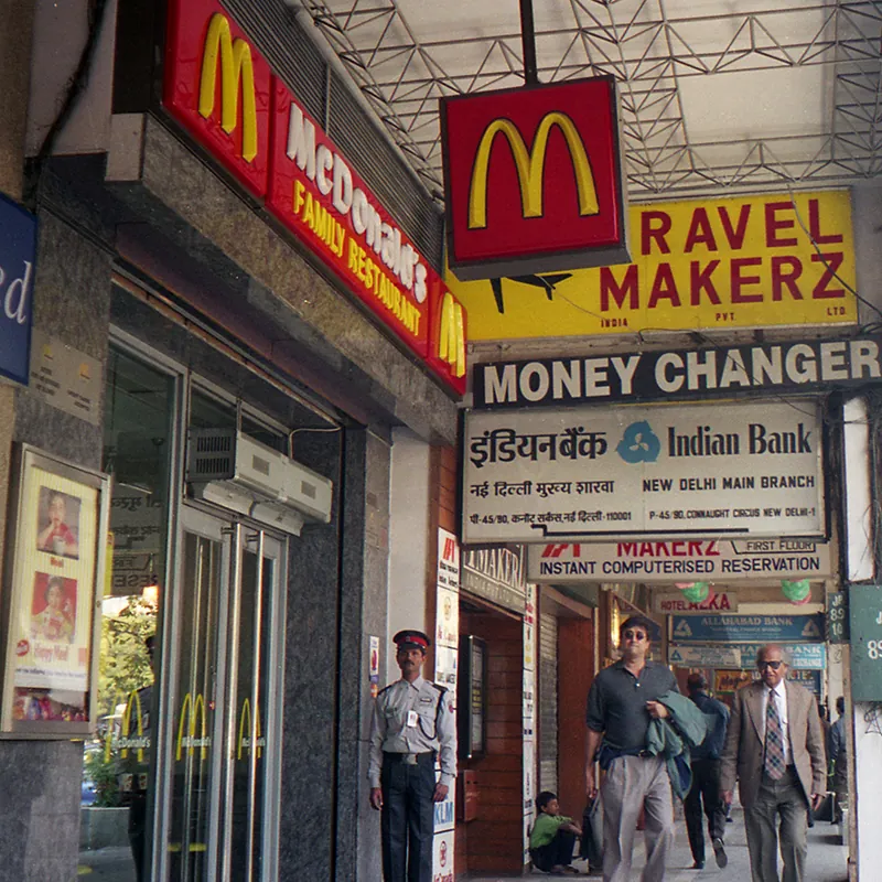A McDonald’s is one of a row of stores on a street in New Delhi, India.