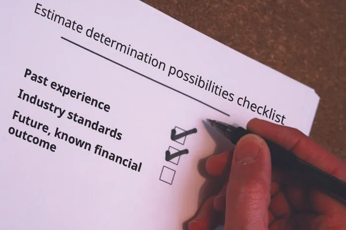 Image shows an estimate determination possibilities checklist. The list includes past experience with a checkmark, industry standards with a checkmark, and future, known financial outcome without a checkmark.