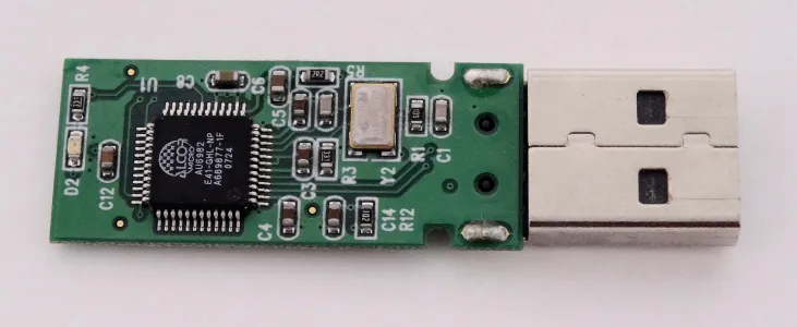 Esta es una fotografía de una placa de circuito impreso con un CI y otros componentes. La placa de circuito impreso está conectada a un conector USB. Las etiquetas de todos los componentes están impresas en la placa.