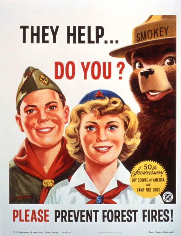 Symbol of wildfire prevention since 1944, Smokey Bear, wearing a hat, stands with two young scouts. The slogan reads, “They help … Do you? Please prevent forest fires.”