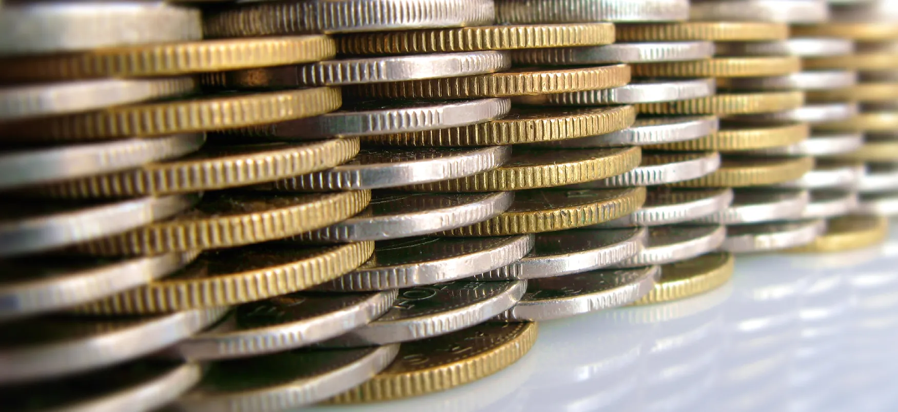 Two different types of coins are stacked together in a repeating pattern.