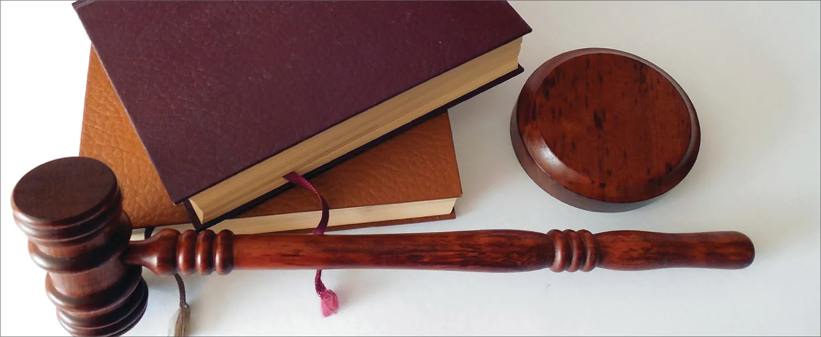 A photo of a gavel and two leather-bound books.