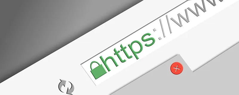 A partially visible computer screen shows a web address beginning with https.
