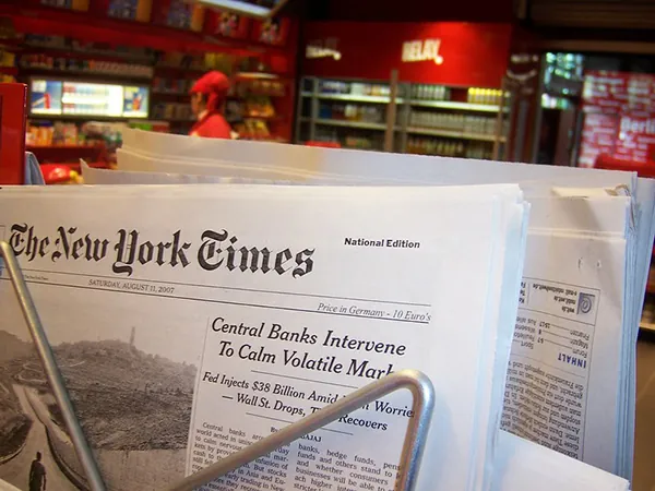 The New York Times newspaper appears on a store newstand.