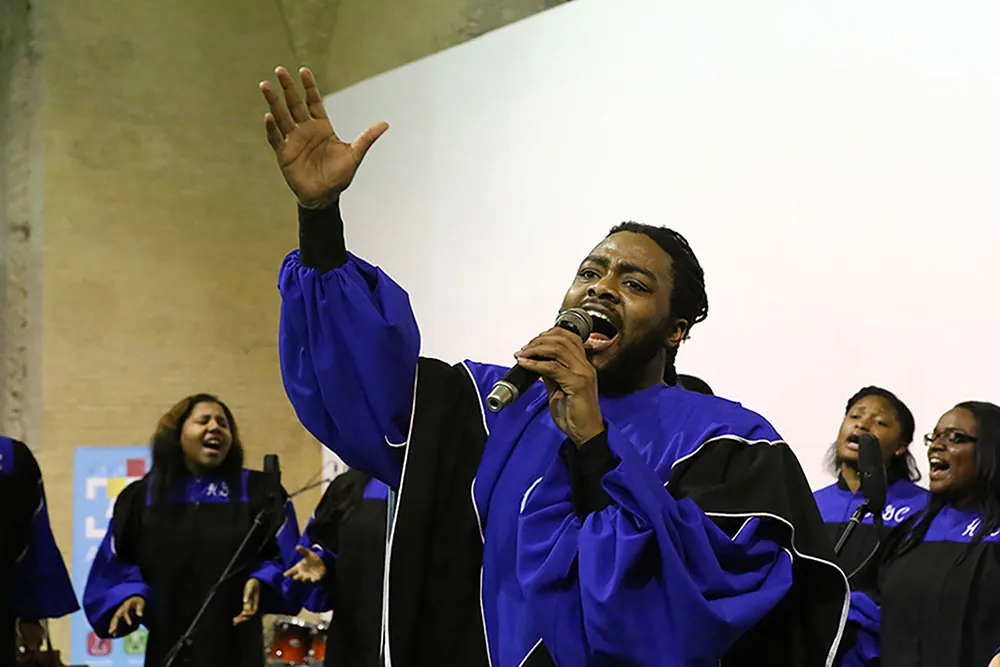 A choir performs with a lead singer in front.