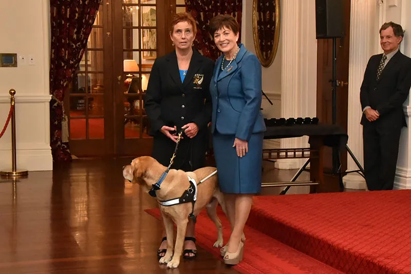 Kaye Kay-Smith, a Paralympian from New Zealand accompanied by a guide dog, is pictured with Governor-General Patsy Reddy.