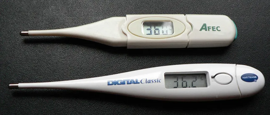 A photograph showing two digital thermometers used for measuring body temperature.