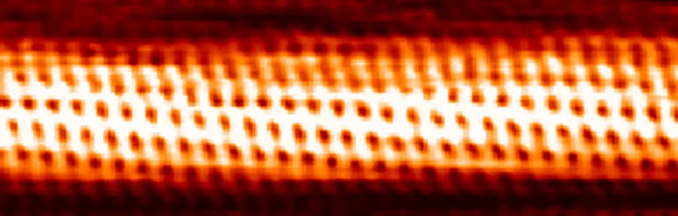 The microscopic image shows carbon atoms in a carbon nanotube.