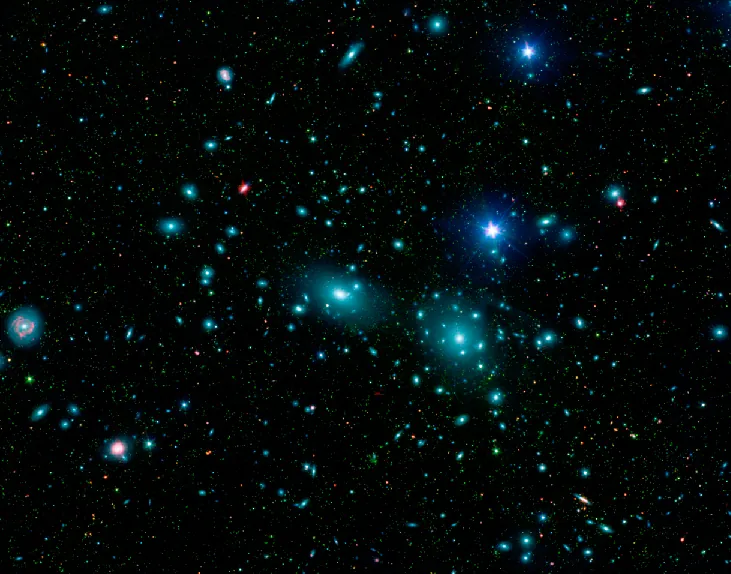 Small Galaxies Outnumber Large Galaxies. This combined visible-light image from the Sloan Digital Sky Survey and infrared Spitzer Space Telescope view of the central region of the Coma Cluster has been color coded so that faint dwarf galaxies are seen as green. Large ellipticals and spirals are few compared to the number of dwarf galaxies.