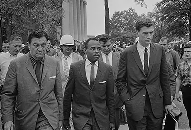 A photograph shows James Meredith entering the University of Mississippi, flanked by a U.S. marshal and the assistant attorney general for civil rights.