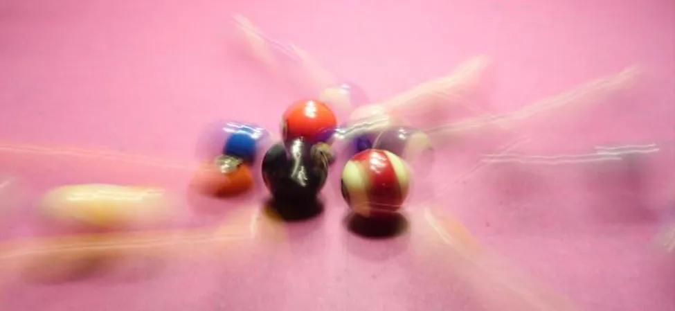 Billiard balls in two-dimensional motion after the initial shot.