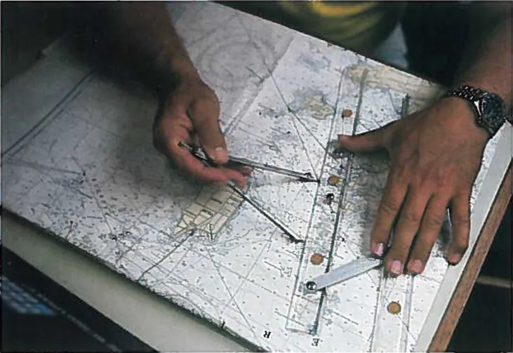 Fotografía de alguien midiendo la distancia en un mapa con calibradores y una regla.