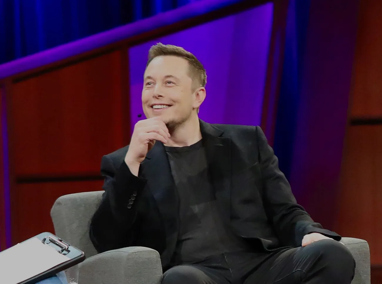 A photograph shows Elon Musk.