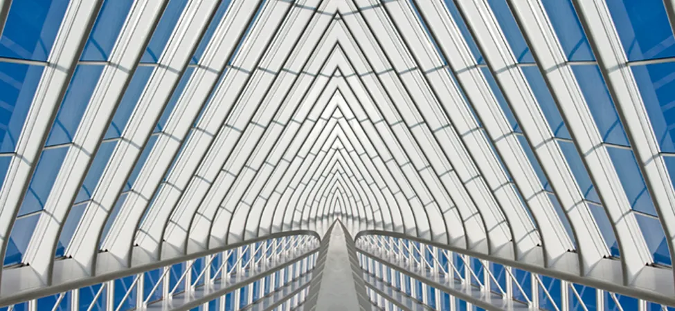 Part of a glass building is shown. The structure is made up of individual shapes.