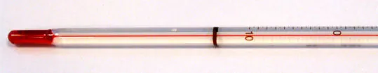 The picture shows the bottom of a thermometer is shown with a red tip and thin line of red extending from the tip to the edge of the picture.