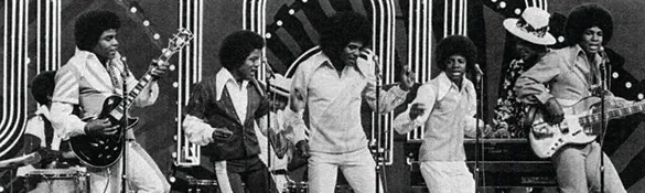 A photograph shows the Jackson Five performing. Each member of the group sports an afro hairstyle.