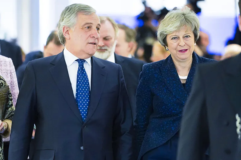 Former British Prime Minister Theresa May walks with the then-President of the European Parliament Antonio Tajani.