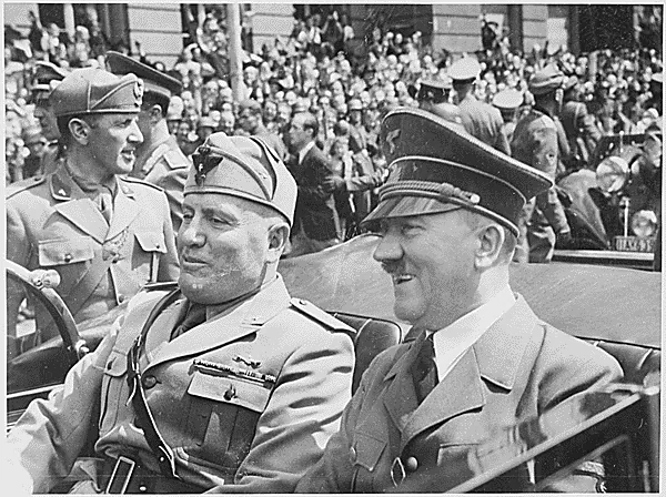 Adolf Hitler and Benito Mussolini are show riding together in a car.