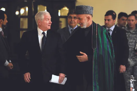 An image of Robert Gates speaking with Hamid Karzai.