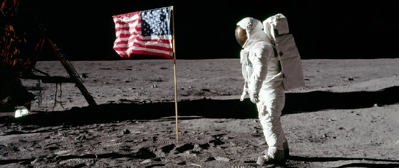 Edwin “Buzz” Aldrin on the Moon. Photograph showing the second man to walk on the Moon facing the American flag erected by the astronauts at the Apollo 11 landing site.