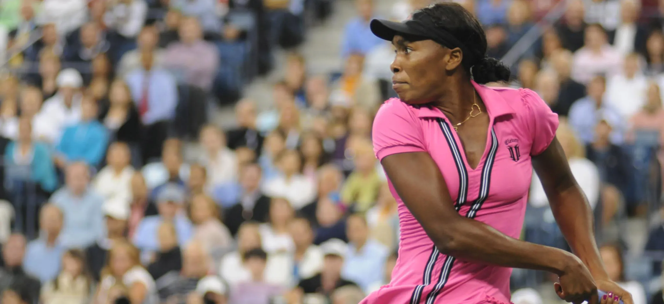 This is a photo of Venus Williams, the famous tennis player, executing a hard tennis swing.