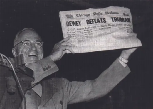 Photo shows Harry S. Truman displaying a newspaper whose headline states “Dewey Defeats Truman.”