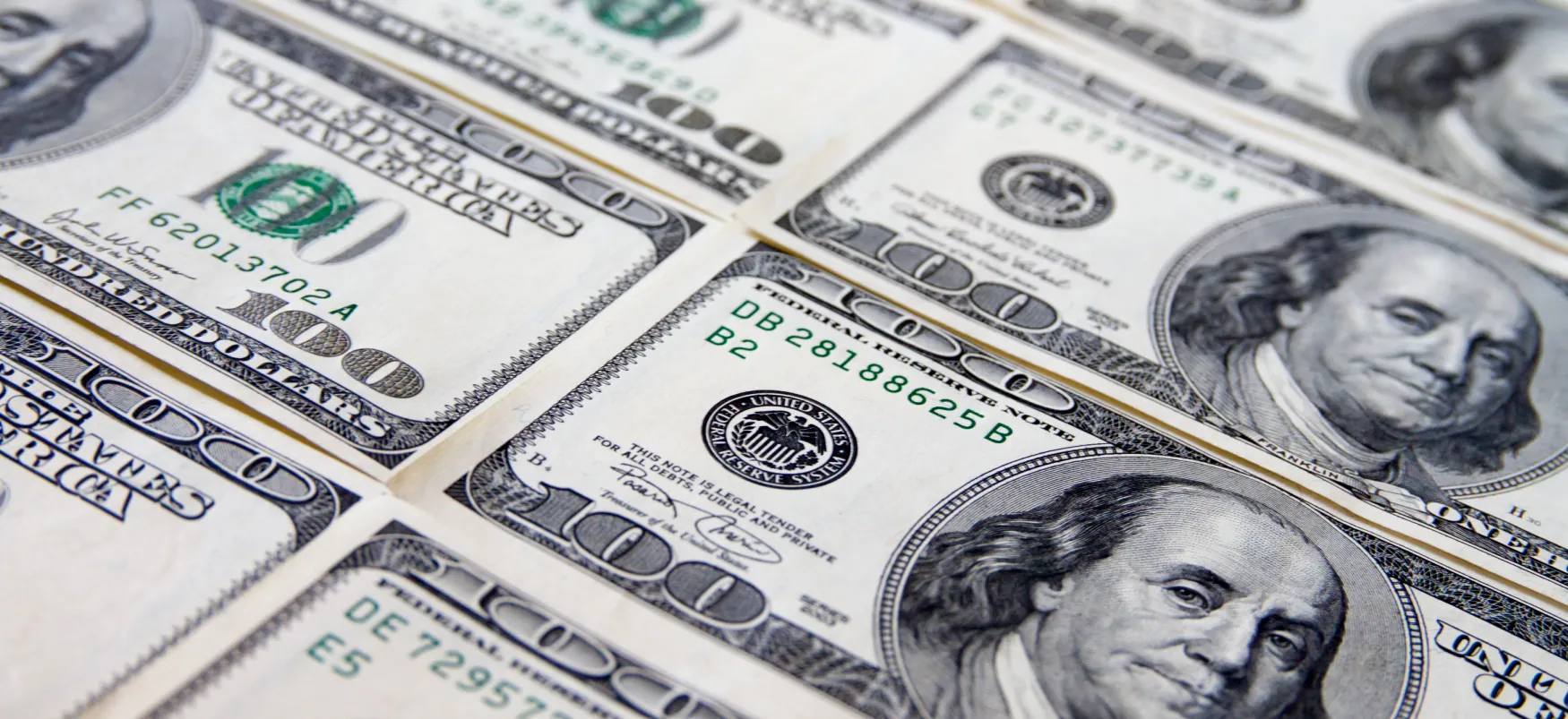 Close-up of stacks of hundred dollar bills.