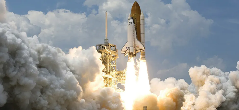 This is an image of a space shuttle blasting off into space.