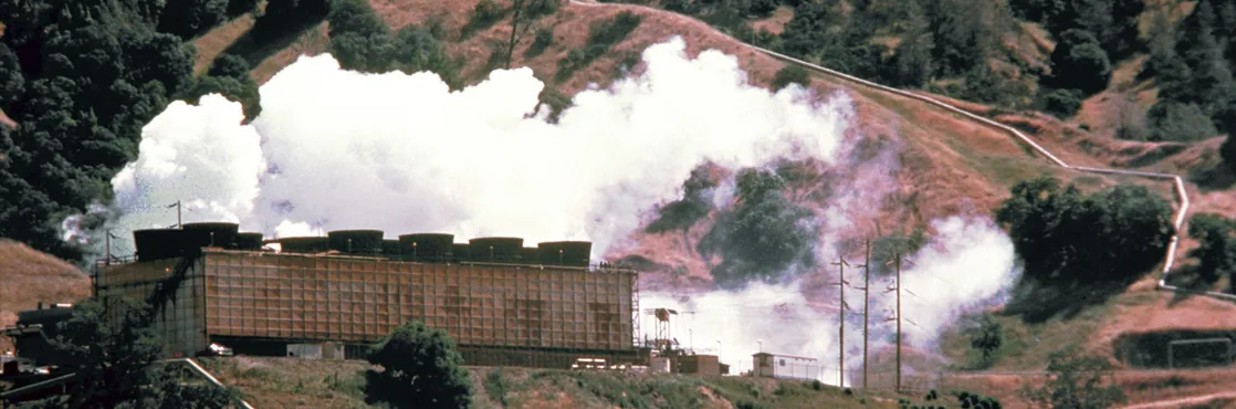 A photograph shows an energy plant on a hillside with clouds of white steam immediately above the plant