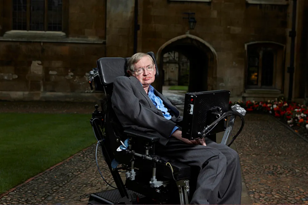 A photo of Stephen Hawking sitting on his special chair fitted with modern gadgets.