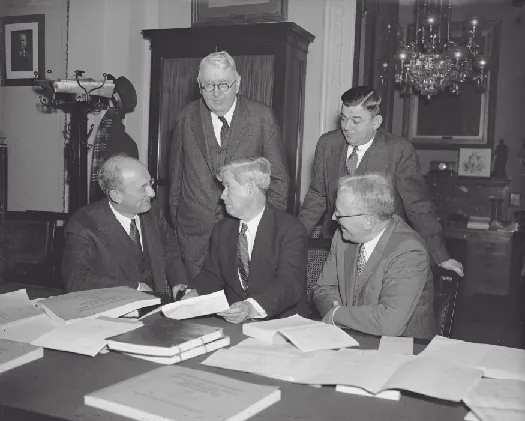 A photo of Henry Morgenthau, Jr., Daniel Bell, and three members of the House Appropriations Committee.