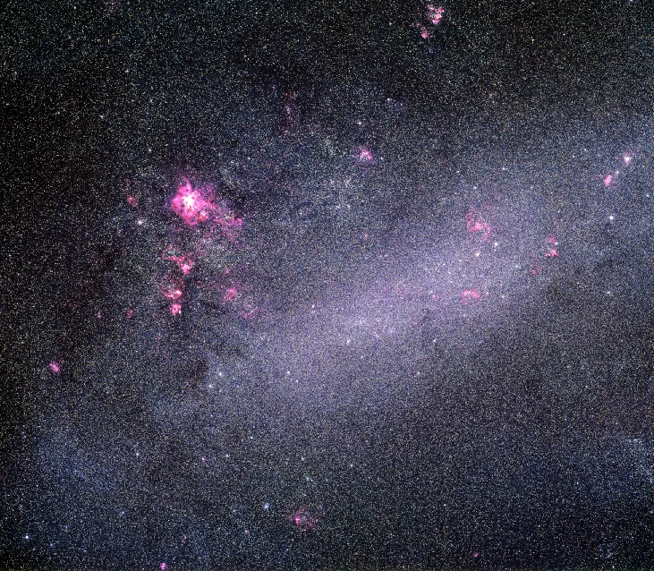 Photograph of the Large Magellanic Cloud. Unlike spiral or elliptical galaxies, the Large Magellanic Cloud does not have a distinct shape and is classified as an irregular galaxy. The main portion of the galaxy is an elongated “bar” of stars, randomly surrounded by bright star clusters and huge regions of luminous gas.