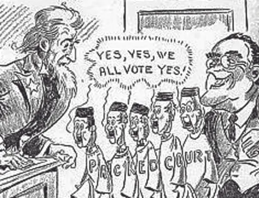 An illustration of seven people. On the left is an Uncle Sam figure. On the right is a person in a suit with a wide grin and glasses. In between the two people are five people in robes. Letters across all of the robes read “Packed Court”. A speech bubble above the five people in robes reads “Yes, Yes, we all vote yes!”.