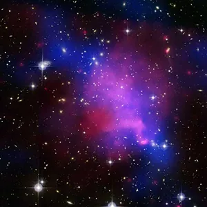 An image of colliding galaxies is shown, with bright stars and colors ranging from blue to purple to pink surrounding the galaxies.