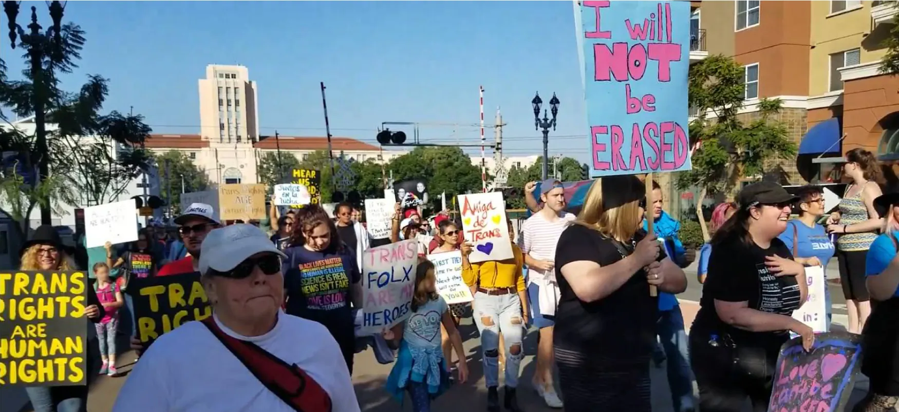 Several hundred protesters can be seen marching downtown in San Diego, California, to support and preserve transgender rights.