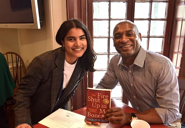 Charles Blow, an American journalist, sits with a student as they discuss Blow’s text Fire Shut Up in My Bones.