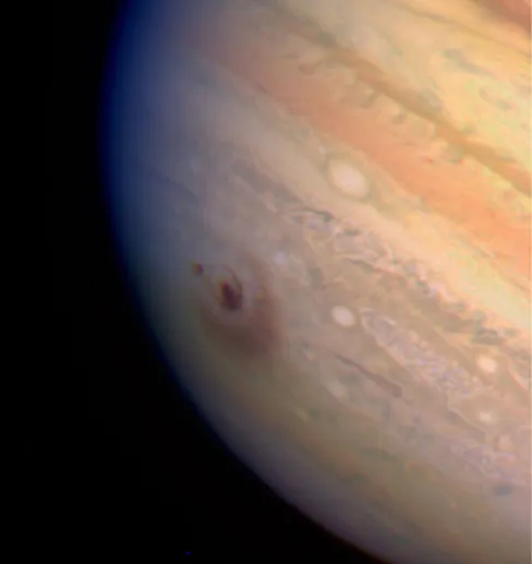 Impact Dust Cloud on Jupiter. The bulls-eye like impact site is visible to the left of center in this HST image of Jupiter.