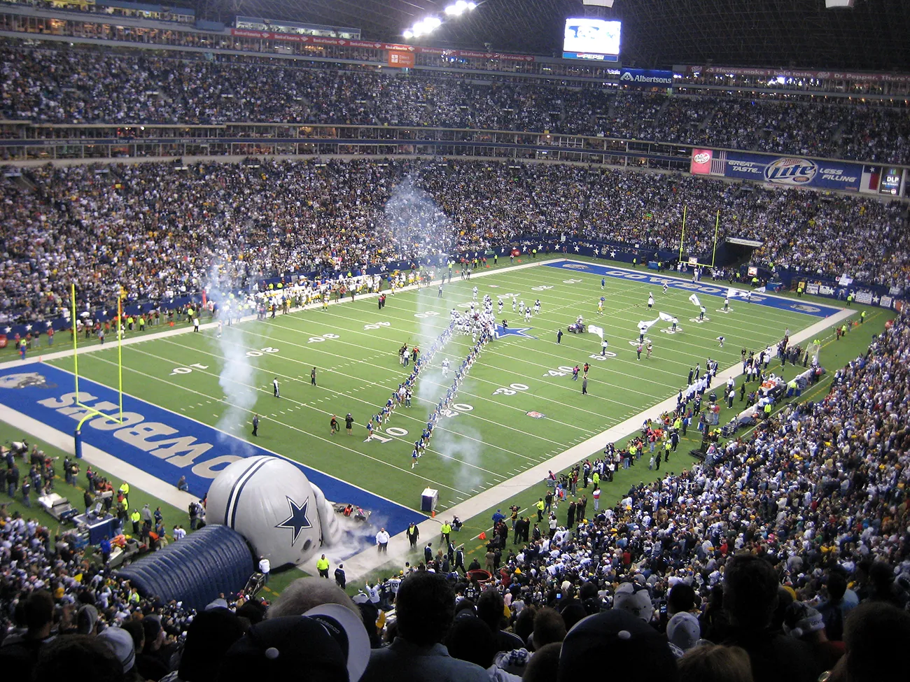 A photograph shows the inside of the stadium during a Dallas Cowboys football game.