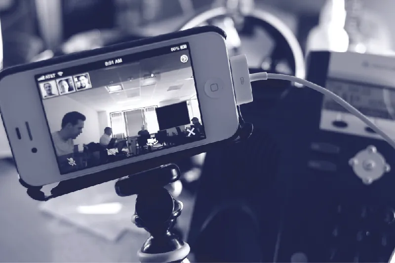 This photo shows a smartphone set up on a tripod for a video conference.