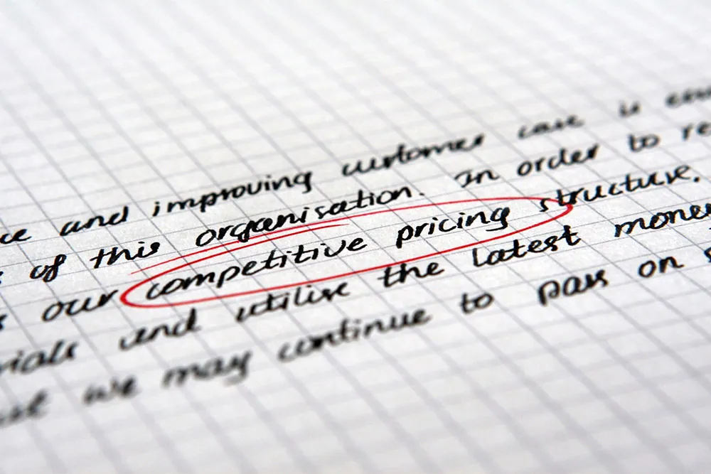 A photo shows the words “competitive pricing” circled on a piece of paper.