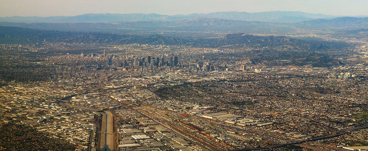 An aerial view of Los Angeles and its surrounding areas. The entire span of the picture contains buildings covering a large area.