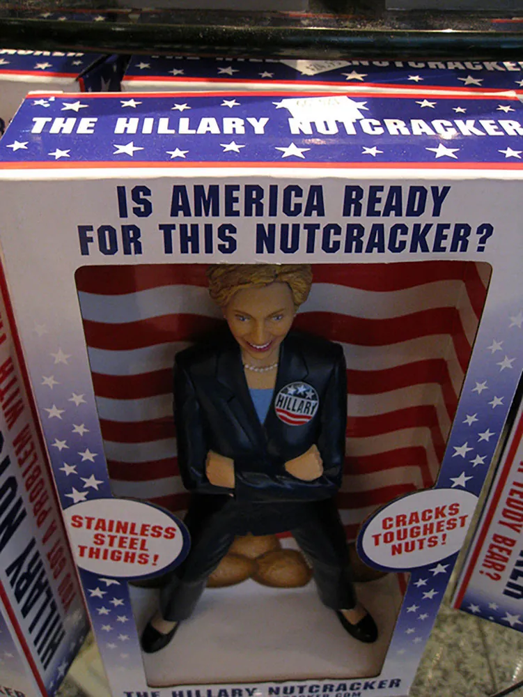 A toy figure of Hilary Clinton is shown in a packaging box reading “Is America Ready for This Nutcracker?”