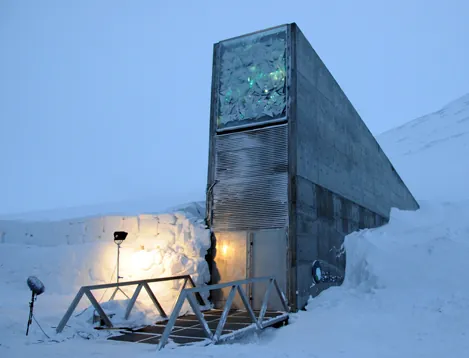  The photo shows a tall structure with a bunker-like door that disappears into a snowbank.