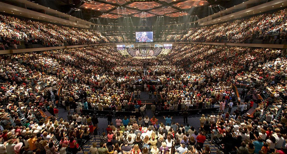 A photo of thousands of people in a stadium during a megachurh ceremony